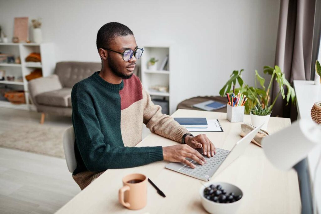 An Arkansas Coding Academy student working on the SQL Intermediate Course at his home office.